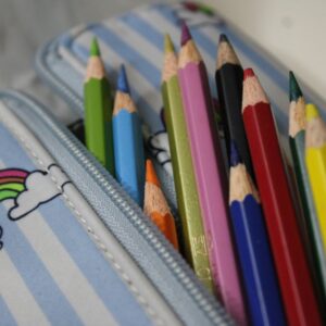 Close-up of colored pencils in a rainbow-themed pencil case.