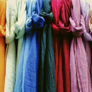 Assorted bright knotted textile made of natural material hanging in local store in daylight