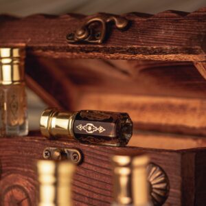 Close-up of antique perfume bottles in an open rustic wooden box, showcasing elegance and luxury.