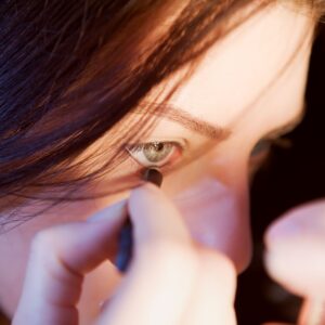 pexels-photo-6713331-6713331 Close-up view of a woman precisely applying eyeliner with focus.